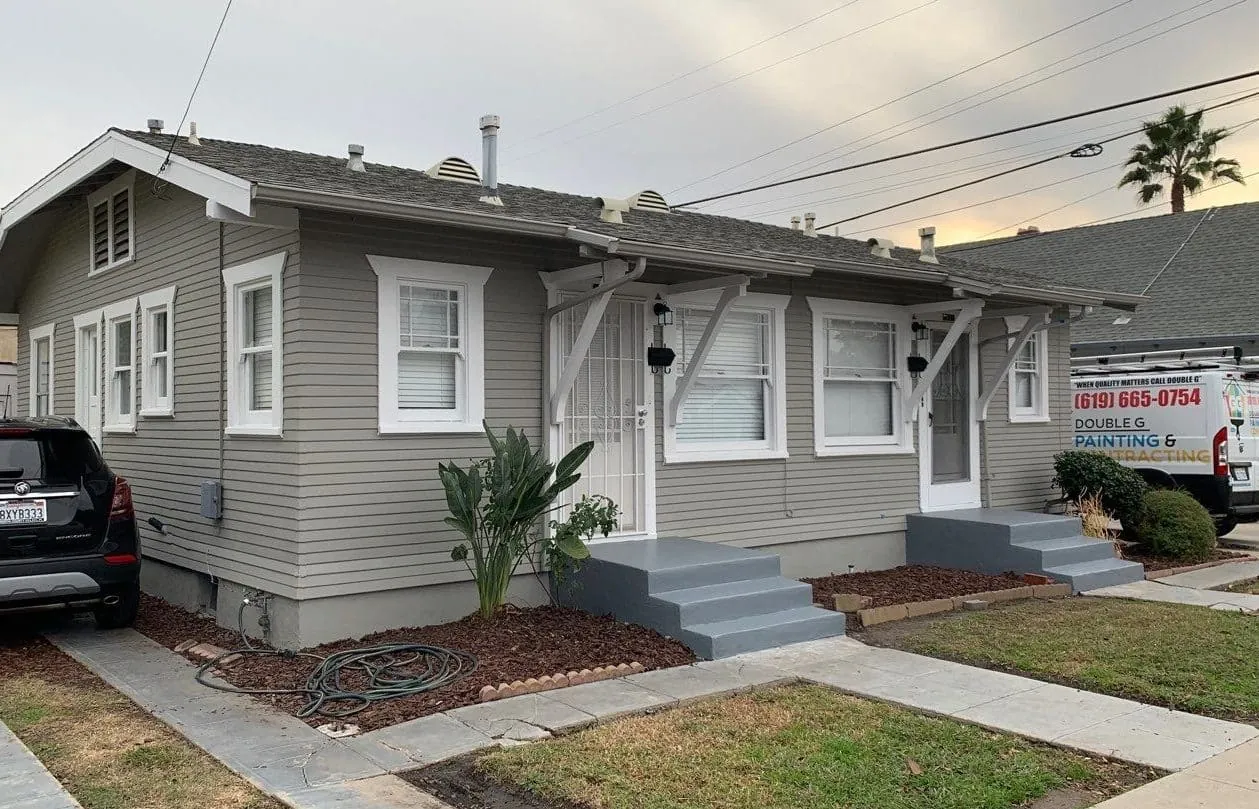 Gray craftsman bungalow after siding repair and repainting