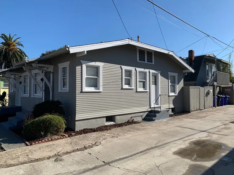 Craftsman bungalow side view with fresh gray paint and white trim