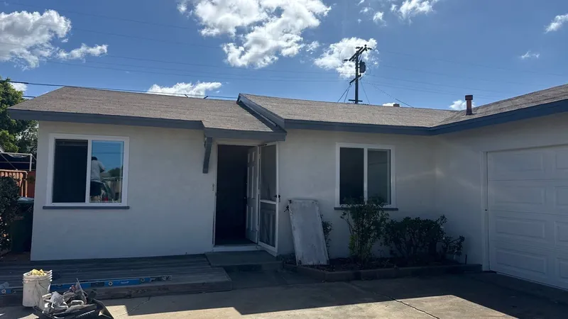 Clairemont ranch home after the renovation in white with charcoal trim