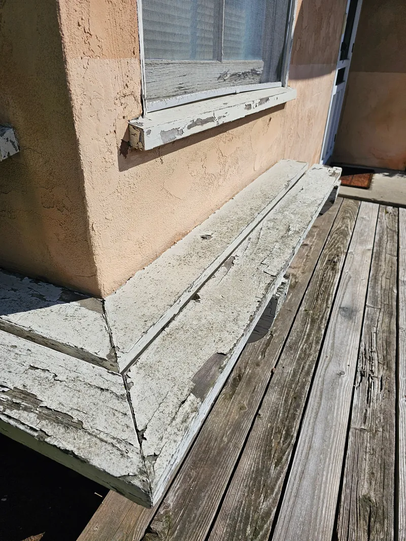 Weathered, peeling window sill and trim before repair