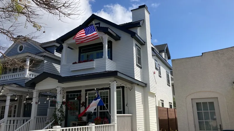 Tall Coronado home with a front porch after exterior painting