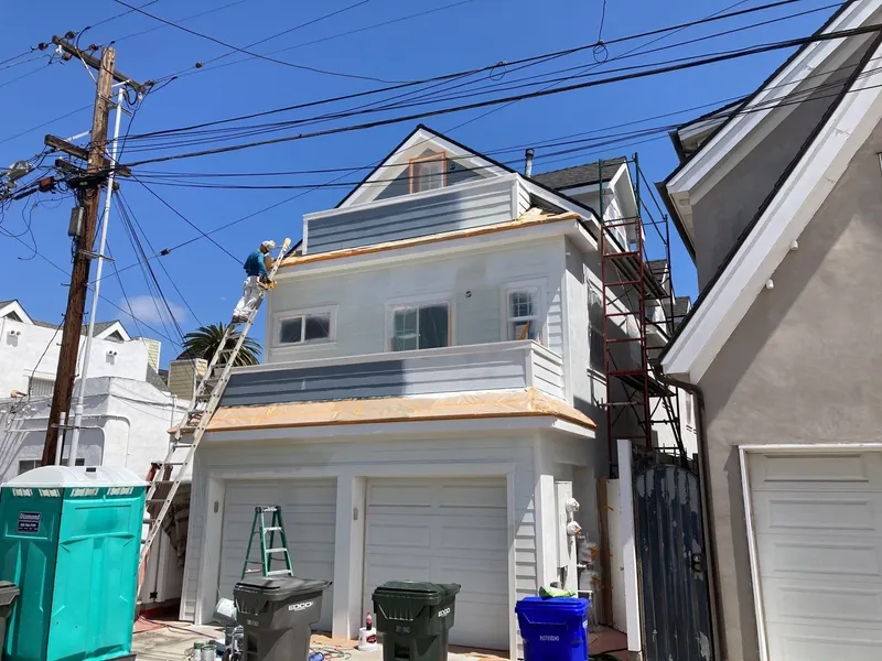 Primed siding and trim on a three-story Coronado home