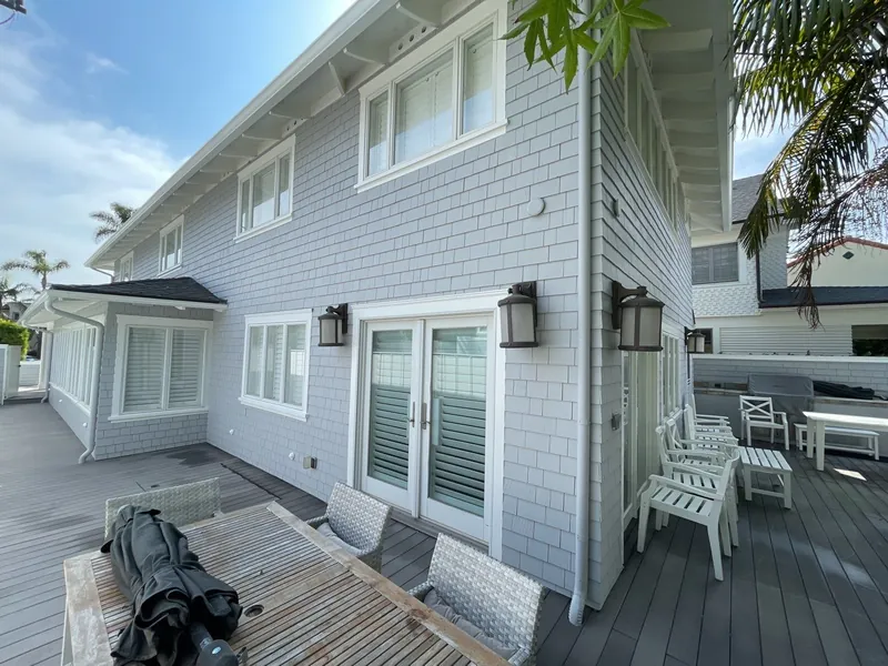 New deck and white shingle siding after a Coronado renovation