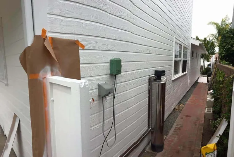 Side yard masked and protected during exterior painting