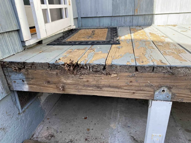 Termite and water damage on a side deck before repairs