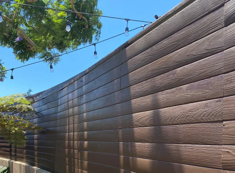 Horizontal wood fence stained a rich brown