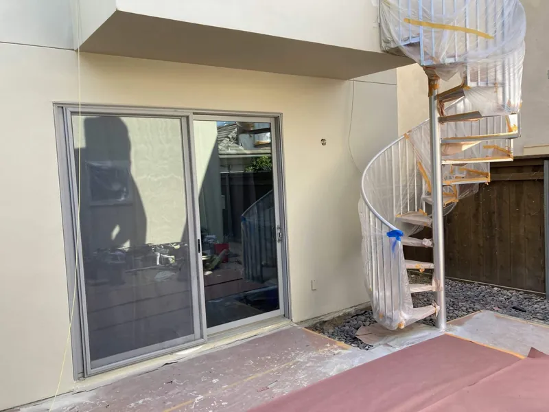 Patio slider and spiral staircase after exterior painting