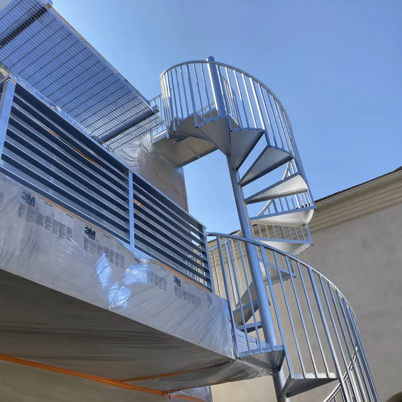 Metal spiral staircase and balcony railing after repainting