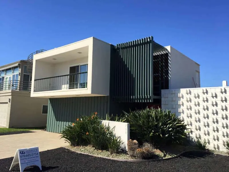 Mid-century home with green board-and-batten siding after painting