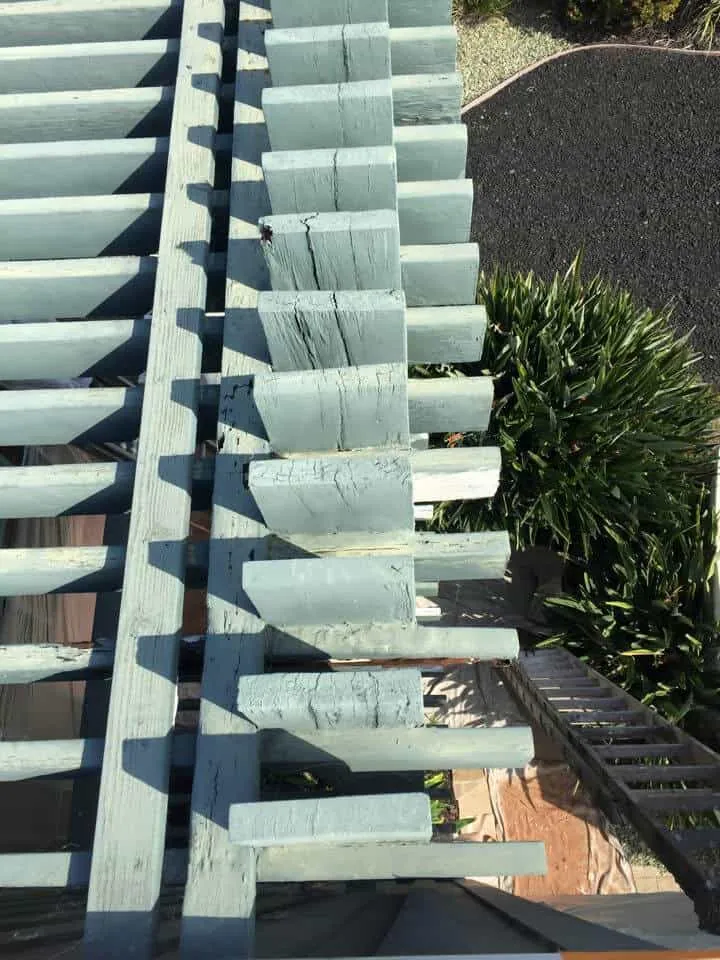 Painted vertical wood slats on a mid-century exterior