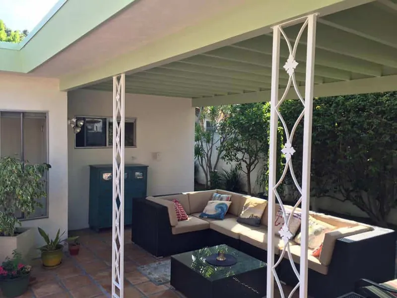 Outdoor lounge with freshly painted white posts and beams