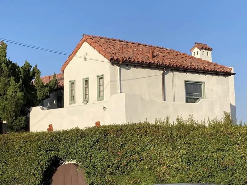 Spanish Revival stucco home with a red tile roof after repainting