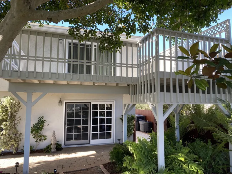 Second-story deck and railings painted white after the project