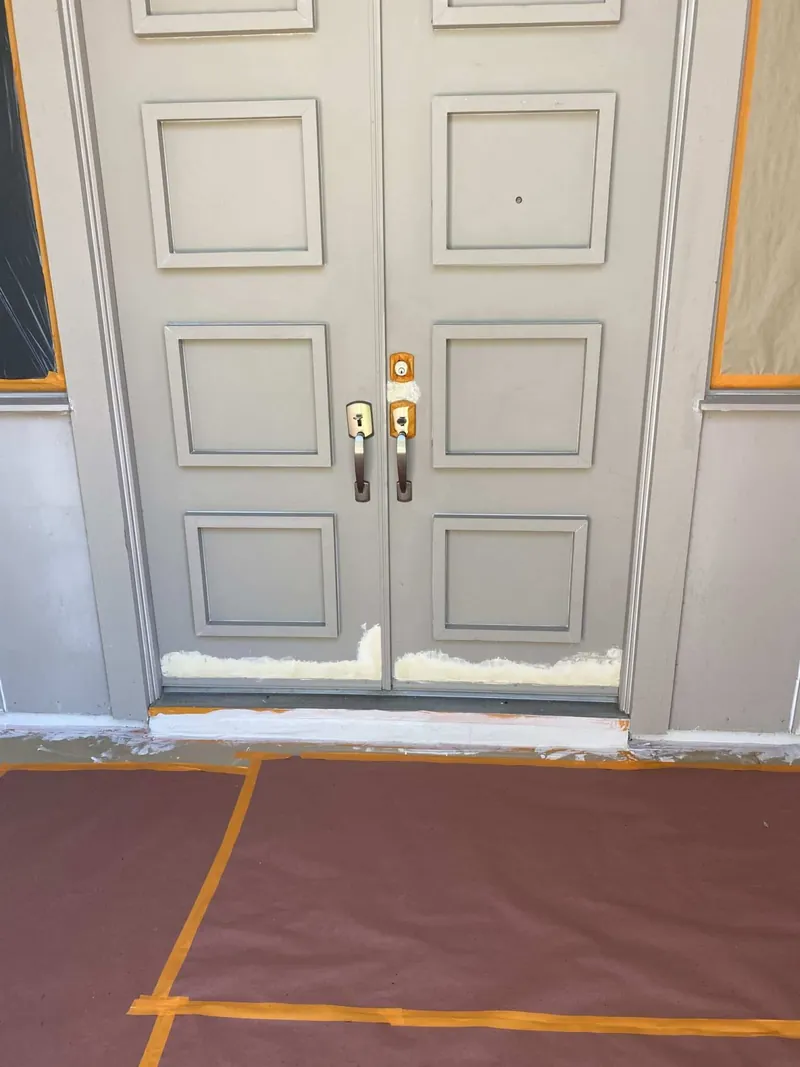 Double front door prepped and masked before painting