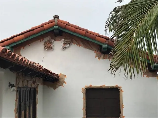 Tile roof eaves and windows masked before painting