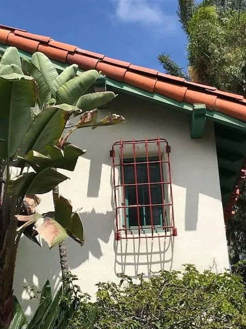 Painted window grille on white stucco
