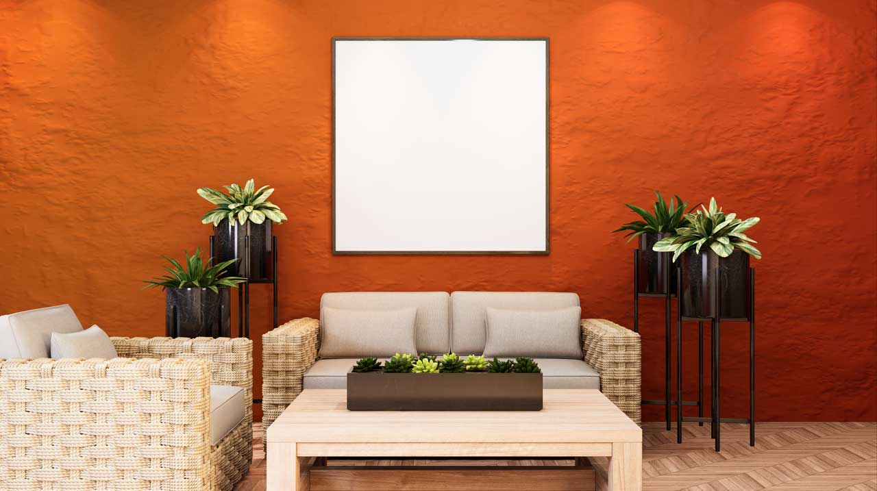 Modern living room with bold orange accent wall refreshed by interior house painters in San Diego