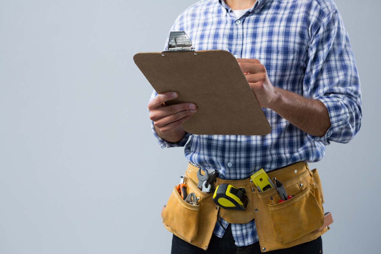 Painting Contractor Paint Inspection Checklist showing a professional contractor reviewing notes with tools ready for a post-holiday home paint inspection.