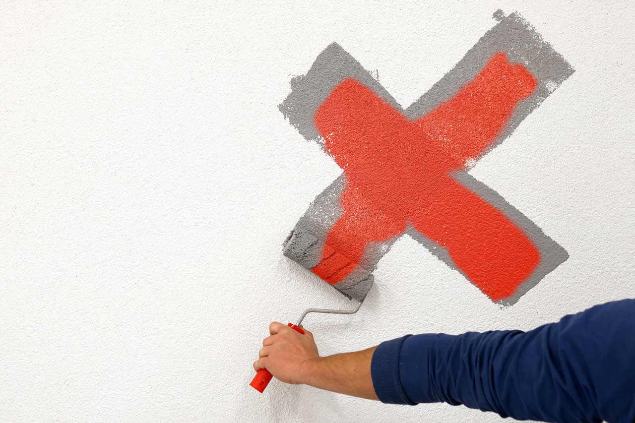 Tips from Residential House Painters showing a wall being repainted to correct winter-related paint stress and surface damage.